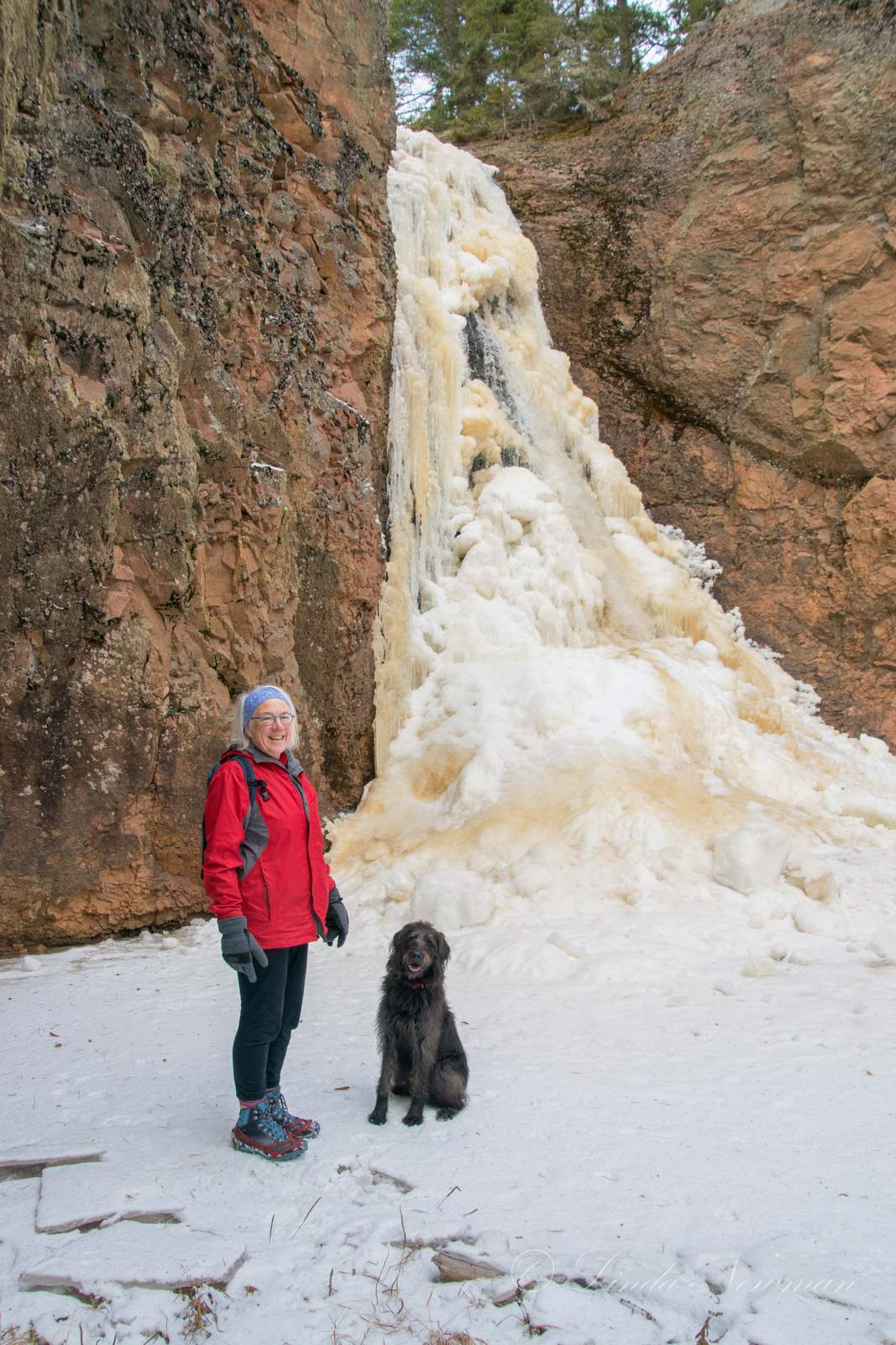 Picture of Mary Ellen exploring frozen river canyons on our River Canyon Snow Treks